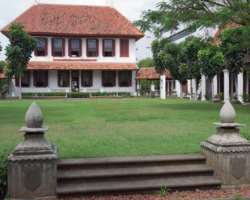It is a two-storeyed Dutch-style house with a surrounding garden. There is also a bell tower in the garden. You can spend a good time in the garden si